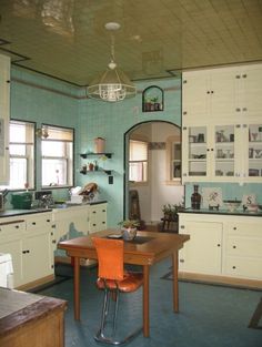 an old fashioned kitchen with blue and white walls