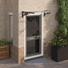 an open door on the side of a brick building next to a planter filled with potted plants