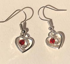 silver plate heart drop earrings with red glass bead Silver plated wires or choose 925 silver wires Drop length 2.5cm Red Nickel-free Dangle Heart Earrings, Adjustable Red Heart Earrings For Gift, Red Sterling Silver Dangle Heart Earrings, Heart-shaped Wire Wrapped Earrings For Gift, Red Sterling Silver Pierced Heart Earrings, Red Metal Earrings For Anniversary, Red Heart-shaped Metal Earrings, Red Heart Charm Metal Earrings, Red Sterling Silver Wire Wrapped Earrings