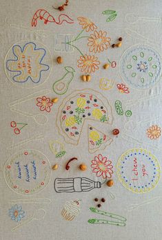 an embroidered table cloth with various designs and beads on it, including flowers, leaves, and other things