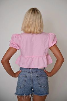 This vibrant pink cropped top combines playful elements with functional design, offering a fresh take on casual wear. Featuring a unique tie-front closure and ruffled details, this piece is perfect for those looking to add a splash of color and whimsy to their wardrobe. Features: Material: Made from a lightweight cotton blend, ensuring comfort and ease of wear. Special Features: This top includes a tie-front design that allows for adjustable fitting and adds a decorative touch. Technical Specifi Chic Cropped Hem Crop Top For Summer, Chic Short Sleeve Crop Top With Ruffles, Trendy Short Sleeve Crop Top With Ruffles, Trendy Ruffled Short Sleeve Crop Top, Trendy Spring Tops With Ruffle Hem, Trendy Ruffle Hem Tops For Spring, Trendy Short Sleeve Ruffled Crop Top, Flirty Short Sleeve Crop Top For Summer, Flirty Short Sleeve Summer Crop Top