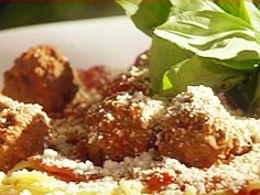 meatballs with sauce and parmesan cheese in a bowl