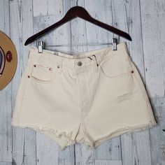 Levi's Women's Shorts High-Rise Fitted Through Hip And Thigh. 100% Cotton Waist 17" Inches Rise 12" Inches Inseam 2.5" Inches White Levi's Bottoms For Summer, White Levi's Shorts With Pockets, White Levi's Shorts For Summer, Levi's Beige Bottoms For Spring, Levi's White Shorts For Summer, Fitted White Levi's Shorts, High Rise Cream Bottoms For Summer, High-rise Cream Bottoms For Summer, Levi's White High-waist Bottoms