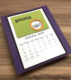 a calendar on a wooden table with the word booo written in it