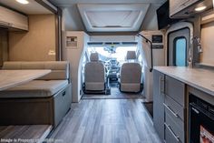 an interior view of a camper van with the kitchen and living room in it