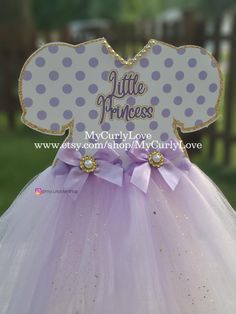 a purple and white dress with polka dots on it that says, little princess my curly love