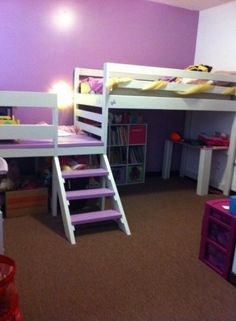 there are two bunk beds with stairs to the top and bottom, in this child's bedroom