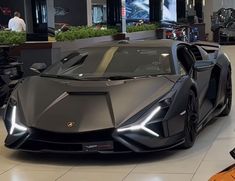 a black sports car is parked in a showroom