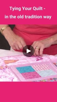 a woman is making a quilt on a table