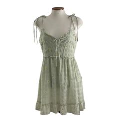 This Dress Is So Cute, Sage, Green With Yellow And White Daisies. Lining. Spaghetti Straps And Tie On Front Bodice With Opening. Ruffles Around Bottom Of Dress And Small Ruffle Around Waist Line. Never Worn. Polyester Lining And Polyester Shell. Spring Cotton Mini Dress With Spaghetti Straps, Spring Green Cami Sundress, Green Cami Sundress For Spring, Green Cami Mini Dress For Spring, Green Mini Dress With Tie Straps For Summer, Spring Cami Mini Dress, Green Spring Cami Dress, Spring Sundress With Spaghetti Straps And Lining, Green Cami Dress For Spring