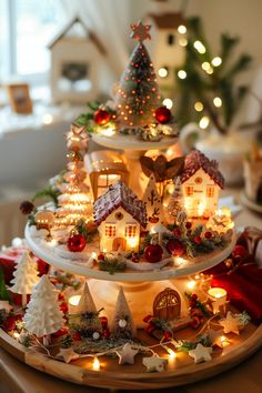 three tiered christmas tree with lit up houses