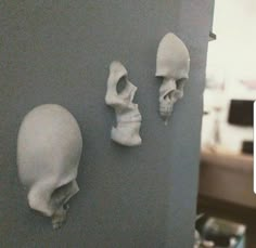 there are three fake skulls on the wall