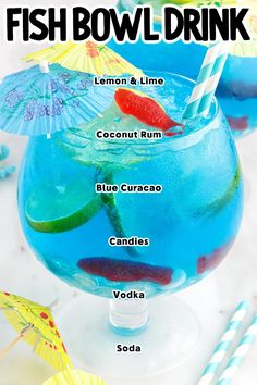 the fish bowl drink is in a glass with straws and umbrellas around it