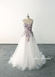 a white and purple wedding dress on a mannequin