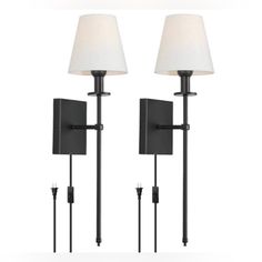 two lamps that are next to each other on a wall mounted light fixture with white shades