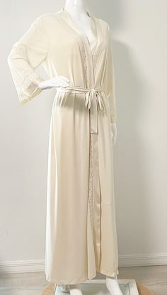 This is a lovely robe and night gown set from Vanity Fair.  The gown ties in the back.  The robe has an inner tie and a sash and one pocket.  Both pieces have inset lace.  Size tag M, nylon.   Measurements taken with robe and nightgown laying flat and doubled where appropriate. In order to determine fit we recommend comparing measurements with an item that fits you well. Gown Length 54 inches Underarm to underarm 34 inches Waist 30 inches Hips 38 inches Robe Length 55 inches Shoulder to shoulder Cream Wedding Night Gown With Lace Trim, Elegant Cream Wedding Nightgown, Cream Lace-trim Sleepwear For Wedding, Cream Wedding Sleepwear With Lace Trim, Elegant Gown With Lace Trim For Daywear, Elegant Daywear Gown With Lace Trim, Elegant Beige Sleepwear For Wedding Night, Feminine Long Robe For Wedding Night, Elegant Cream Nightgown For Sleep