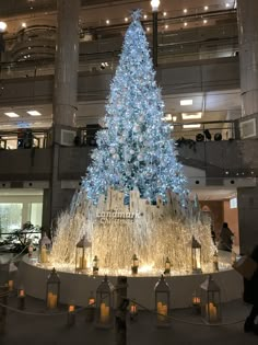 a large christmas tree in the middle of a building