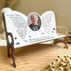 a memorial bench with a photo and poem on it