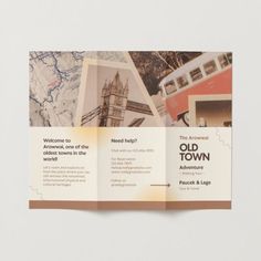 an old town brochure is displayed on a white surface