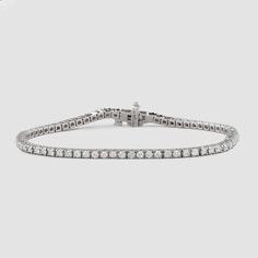 Named after women’s tennis champion Chris Evert, who lost a similar style on the 1987 US Open court, this flexible, close-set diamond bracelet comes adorned with a securely designed clasp that fluidly moves with every gesture (so it’ll stay with you forever). A perennial classic in every era, the single strand looks radiant alone for 1.8-carats of delicate sparkle and layers with other styles for a more subdued shimmer. Custom sizes are available upon request. Presented in our signature Noémie o Timeless Platinum Diamond Bracelet With Accents, Timeless Diamond Tennis Bracelet, Timeless Diamond White Tennis Bracelet With Diamond Accents, Timeless Diamond Tennis Bracelet With Round Cut, Timeless Diamond White Tennis Bracelet With Round Cut, Timeless Round Cut Diamond Tennis Bracelet, Luxury Diamond Bracelet With Brilliant Cut, Luxury Platinum Diamond Bracelet With Brilliant Cut, Timeless Platinum Diamond Bracelet With Single Cut Diamonds