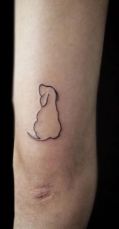 a small dog tattoo on the leg