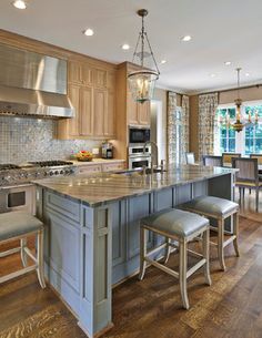 a large kitchen with an island in the middle