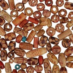 several wooden beads with designs on them