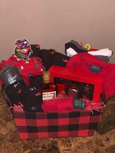 a red and black basket filled with items on top of a counter next to a wall