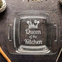 a glass tray with the words queen of the kitchen on it and utensils