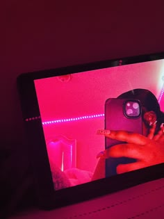 someone is taking a photo with their cell phone in the dark, and it's pink