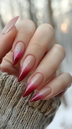 The image shows a hand with long, stiletto-shaped nails. The nails are painted with a red and silver glitter ombre design ->> more details in ai-img-gen.com Red Ombre Nails Design, Ombre Nails Glitter Red, Red Nail With Glitter, Gel X Red Nails, Red And Silver Nails Ideas, Red Nail Ombre, Red And Glitter Nail Designs, Red Detail Nails, Red And Silver Glitter Nails