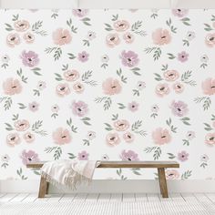 a bench in front of a floral wallpaper with pink and purple flowers on it