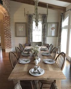 the dining room table is set with plates and place settings for six people to eat