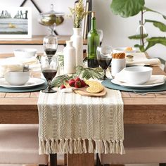 the table is set with plates, bowls and cups