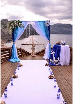 an outdoor wedding setup on the deck of a boat with blue and white drapes