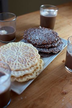 there are some desserts on the table with drinks