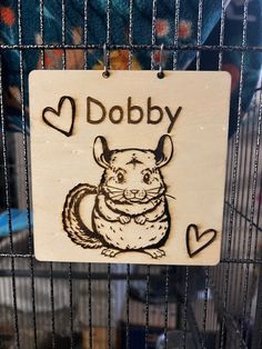 a sign that says dobby on it in front of a cage with other items