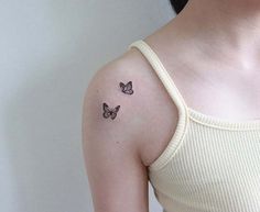 two butterflies tattoo on the left shoulder and right arm, with one butterfly in the middle