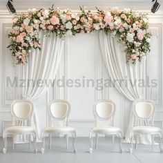 three white chairs with flowers on them in front of an arch decorated with curtains and drapes