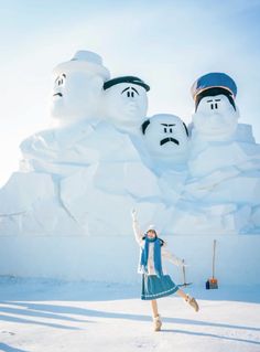 a woman standing in front of snow sculptures