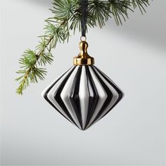 a black and white ornament hanging from a christmas tree