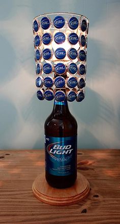 a beer bottle sitting on top of a wooden table next to a glass cup holder