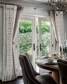 a dining room table with chairs and a chandelier