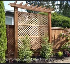 a wooden fence surrounded by plants and trees