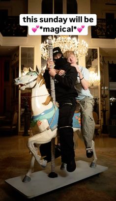 two people hugging on a merry go round horse