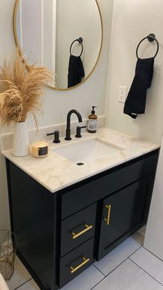 a bathroom with a sink, mirror and towel rack