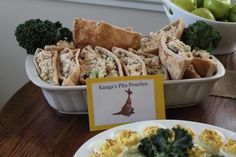 an assortment of food items displayed in bowls and plates on a table with greeting cards