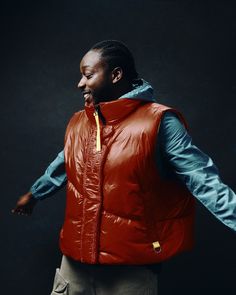 a man wearing a red vest and blue shirt