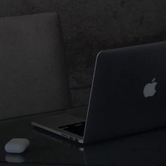 an apple laptop computer sitting on top of a table next to a mouse and keyboard