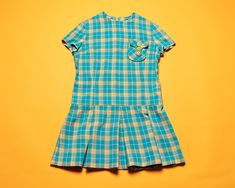 Take a look at this fantastic vintage 60's dress in a blue and yellow plaid pattern. The design features a zip fastener at the side, a low waist and a pleated skirt. Made of wool blend. Vintage condition level: 8/10.* Shows overall wear but nothing in particular. SIZE. Marked size 164 which is approx. 13-14 years. To be sure it would fit please check the measurements below.  FLAT Measurements: Length: 30 1/2" / 77.5 cm Armpit to armpit: 17" / 43 cm Shoulder to shoulder: 14 1/2'' / 37 cm Sleeve: Retro Short Sleeve School Dresses, Retro Short Sleeve Plaid Dress, Summer Dress Blue, 60s Girl, Mod Dress 60s, Level 8, Vintage Dress 60s, Vintage Girls Dresses, 60's Dress